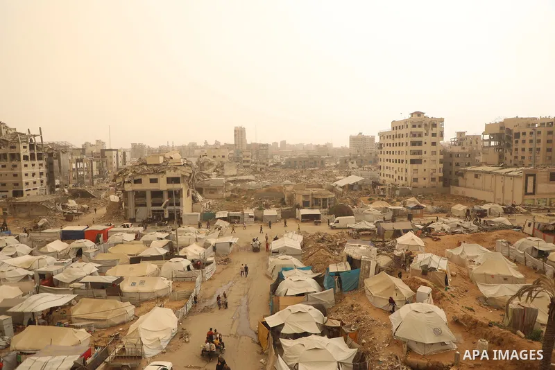 Palestinians walk amidst dust during a sand storm in Gaza City on April 30, 2025. The UN food agency, one of the main providers of food assistance in the besieged Palestinian territory said on April 25 it had "delivered...