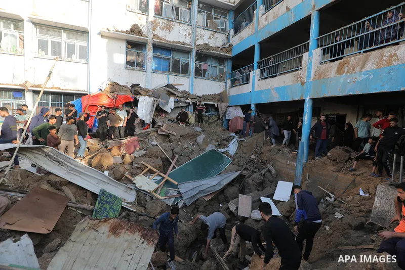 Palestinians inspect the damage caused by an Israeli airstrike targeting a school housing displaced people in Al-Bureij refugee camp in the central Gaza Strip, on May 6, 2025. Photo by Moiz Salhi \ apaimages
