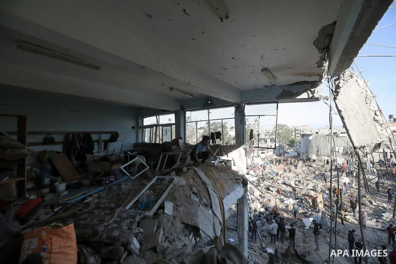 Palestinians inspect the damage caused by an Israeli airstrike targeting a school housing displaced people for the second time in Al-Bureij refugee camp in the central Gaza Strip, on May 7, 2025. Photo by Moiz Salhi \ ap...