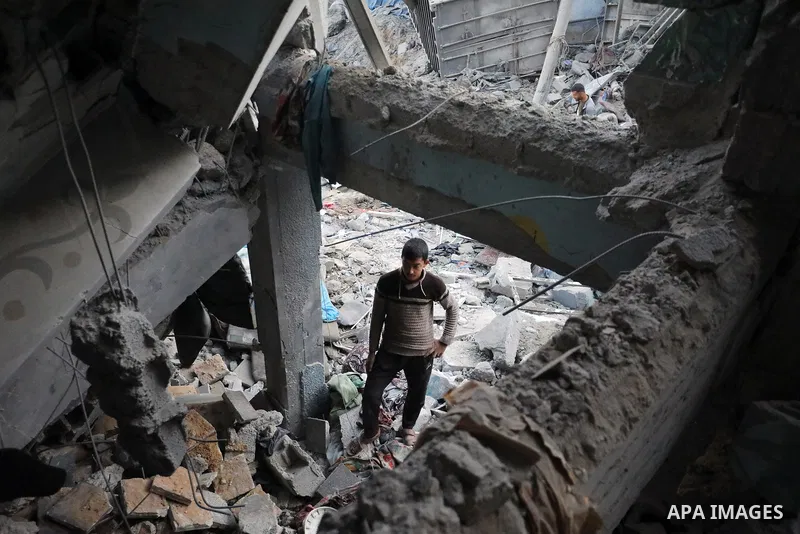 Palestinians inspect the damage caused by an Israeli airstrike targeting a school housing displaced people for the second time in Al-Bureij refugee camp in the central Gaza Strip, on May 7, 2025. Photo by Moiz Salhi \ ap...