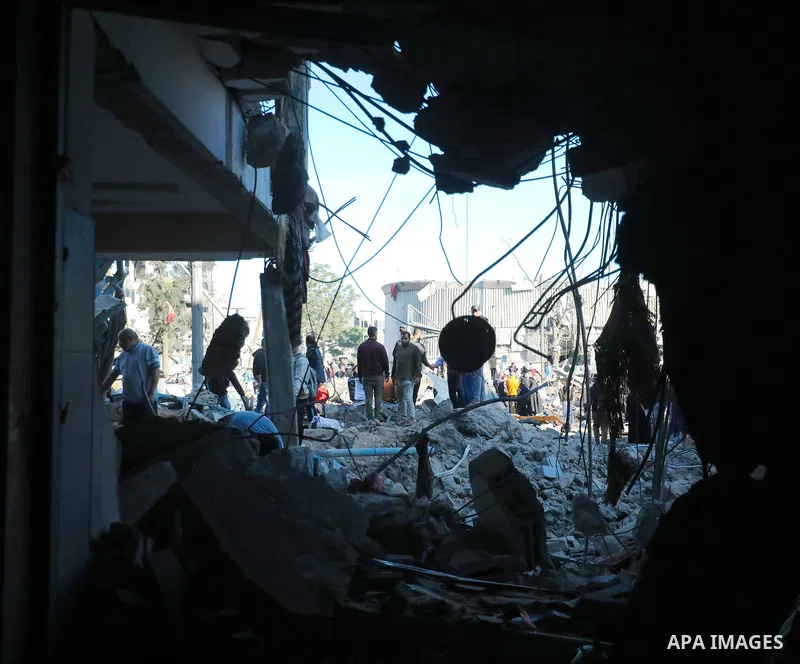 Palestinians inspect the damage caused by an Israeli airstrike targeting a school housing displaced people for the second time in Al-Bureij refugee camp in the central Gaza Strip, on May 7, 2025. Photo by Moiz Salhi \ ap...