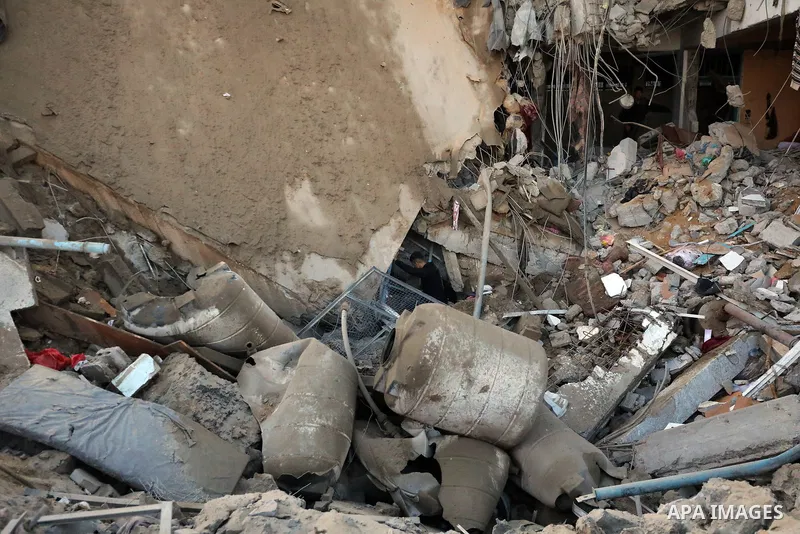 Palestinians inspect the damage caused by an Israeli airstrike targeting a school housing displaced people for the second time in Al-Bureij refugee camp in the central Gaza Strip, on May 7, 2025. Photo by Moiz Salhi \ ap...