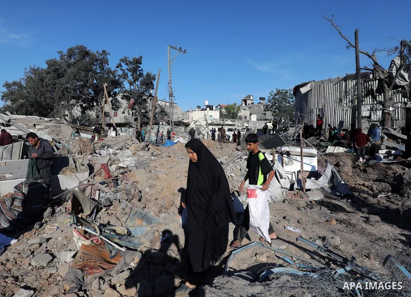 Palestinians inspect the damage caused by an Israeli airstrike targeting a school housing displaced people for the second time in Al-Bureij refugee camp in the central Gaza Strip, on May 7, 2025. Photo by Moiz Salhi \ ap...
