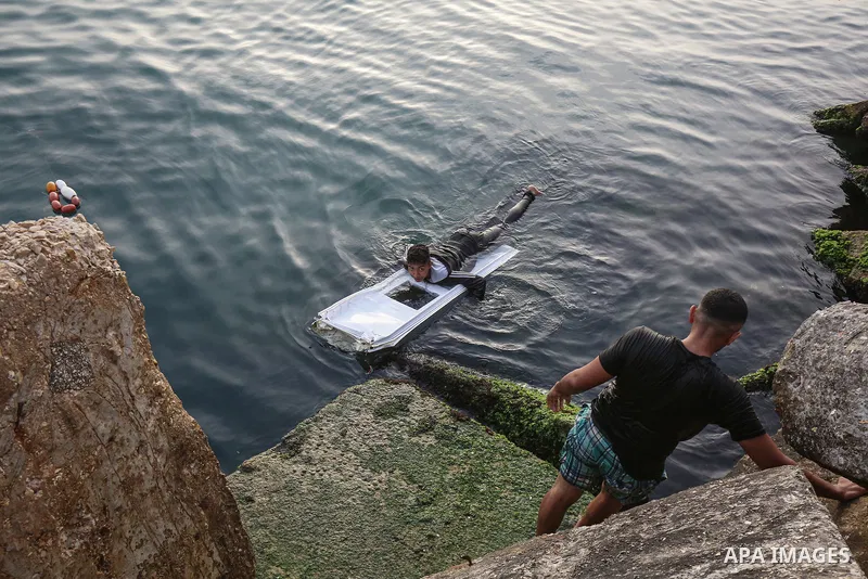 Palestinians, struggling with harsh living conditions due to ongoing Israeli attacks on the Gaza Strip and an intensifying heatwave, gather on the coast to cool off, spending the evening hours by the seaside to escape th...