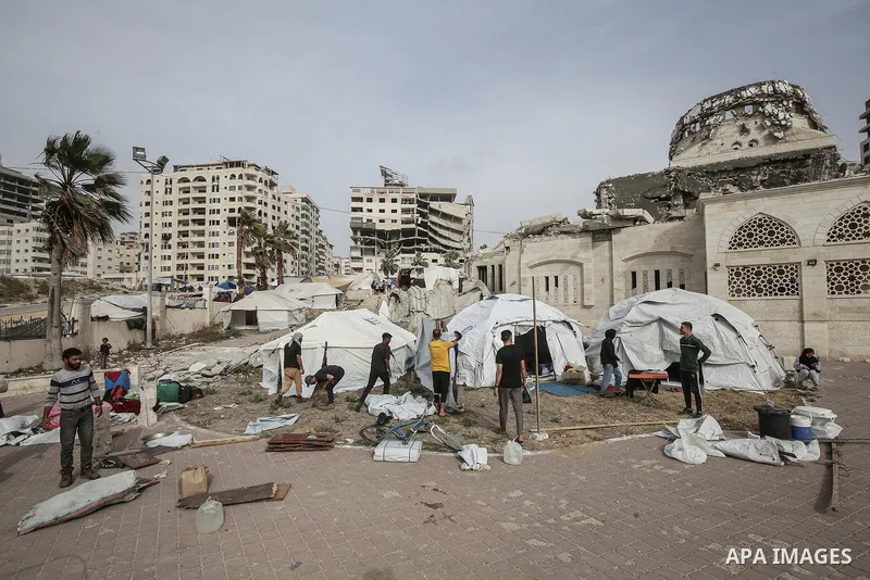 Displaced Palestinians set up makeshift tents at the Gaza Port for shelter following Israel attacks on northern of Gaza Strip, on May 18, 2025. Civilians forced to flee from the northern and eastern regions now live in m...