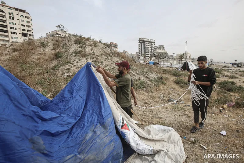 Displaced Palestinians set up makeshift tents at the Gaza Port for shelter following Israel attacks on northern of Gaza Strip, on May 18, 2025. Civilians forced to flee from the northern and eastern regions now live in m...