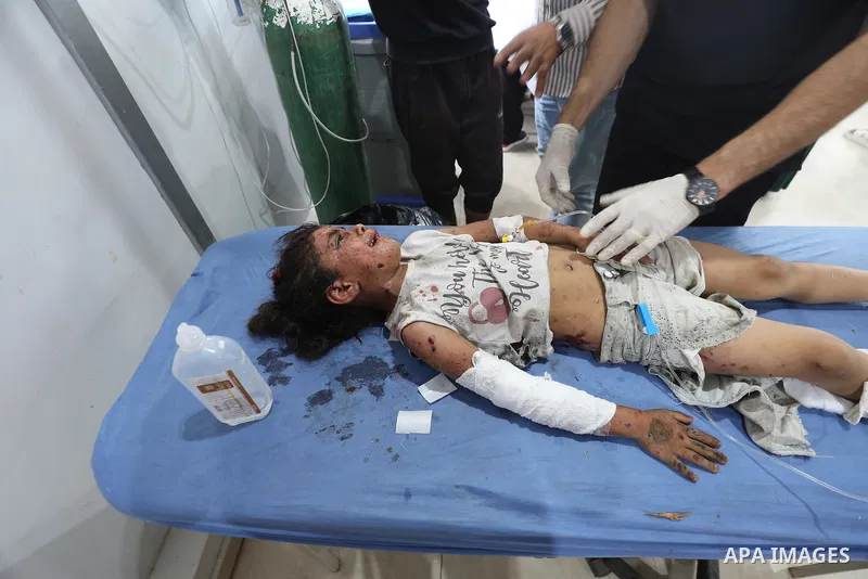 Plestinians transport the wounded and those who lost their lives incloud childern to Al-Awda Hospital after an Israeli bombing on school sheltering displaced people in the Nuseirat camp in the central Gaza Strip, on May...