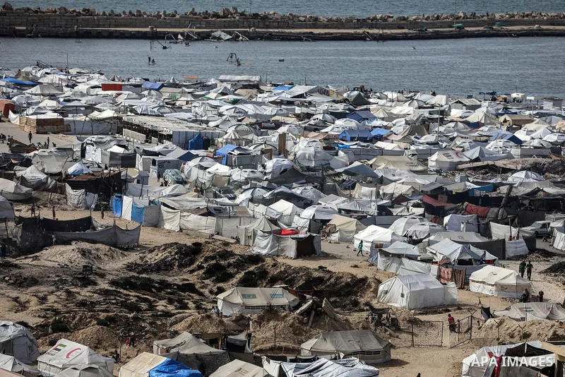 Displaced Palestinians have sought refuge at Gaza's port, where they are enduring harsh conditions in makeshift tents erected along the coastline and public squares in the west of the city, on May 27, 2025 in Gaza City,...