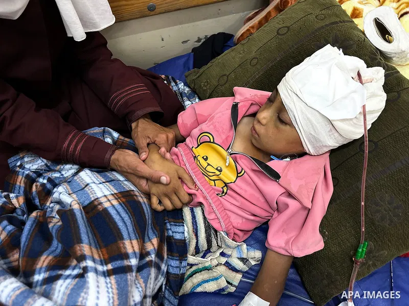 Palestinian child Mais Abdel Aal, 10 years old and displaced to the Al-Mawasi area west of Khan Younis, is receiving medical care at Nasser Medical Complex after being shot by a drone while inside the tent sheltering her...