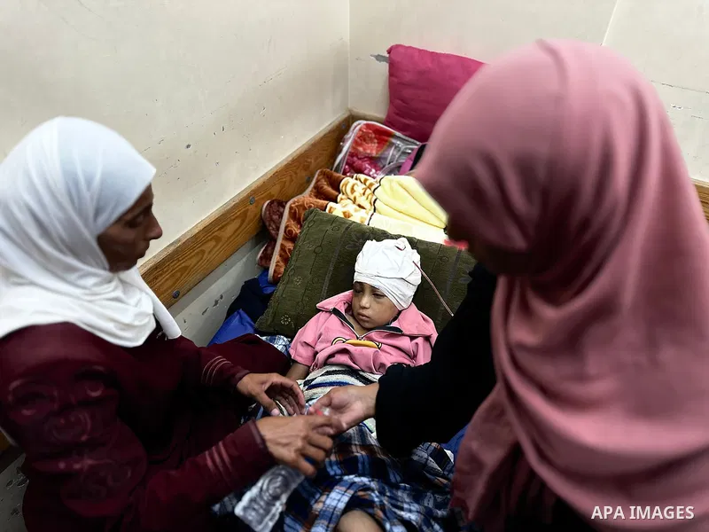 Palestinian child Mais Abdel Aal, 10 years old and displaced to the Al-Mawasi area west of Khan Younis, is receiving medical care at Nasser Medical Complex after being shot by a drone while inside the tent sheltering her...