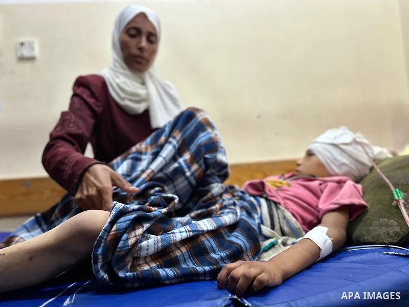 Palestinian child Mais Abdel Aal, 10 years old and displaced to the Al-Mawasi area west of Khan Younis, is receiving medical care at Nasser Medical Complex after being shot by a drone while inside the tent sheltering her...