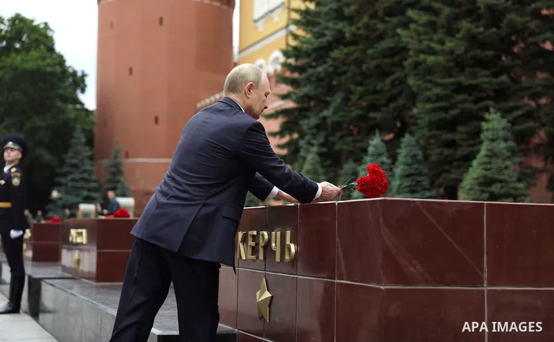 Russia's President Vladimir Putin and Russian Defence Minister Andrei Belousov attend a wreath-laying ceremony at the Tomb of the Unknown Soldier in the Alexandrovsky Garden near the Kremlin wall to commemorate the 84th...