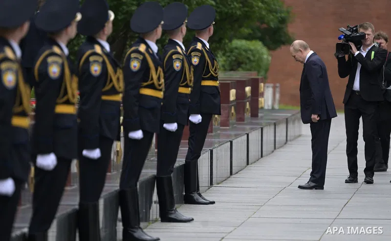Russia's President Vladimir Putin and Russian Defence Minister Andrei Belousov attend a wreath-laying ceremony at the Tomb of the Unknown Soldier in the Alexandrovsky Garden near the Kremlin wall to commemorate the 84th...