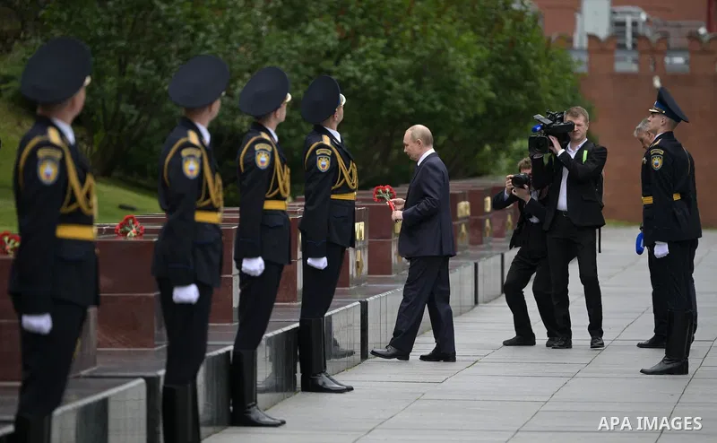 Russia's President Vladimir Putin and Russian Defence Minister Andrei Belousov attend a wreath-laying ceremony at the Tomb of the Unknown Soldier in the Alexandrovsky Garden near the Kremlin wall to commemorate the 84th...