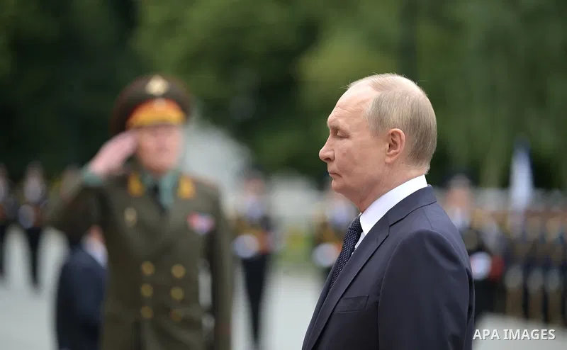 Russia's President Vladimir Putin and Russian Defence Minister Andrei Belousov attend a wreath-laying ceremony at the Tomb of the Unknown Soldier in the Alexandrovsky Garden near the Kremlin wall to commemorate the 84th...