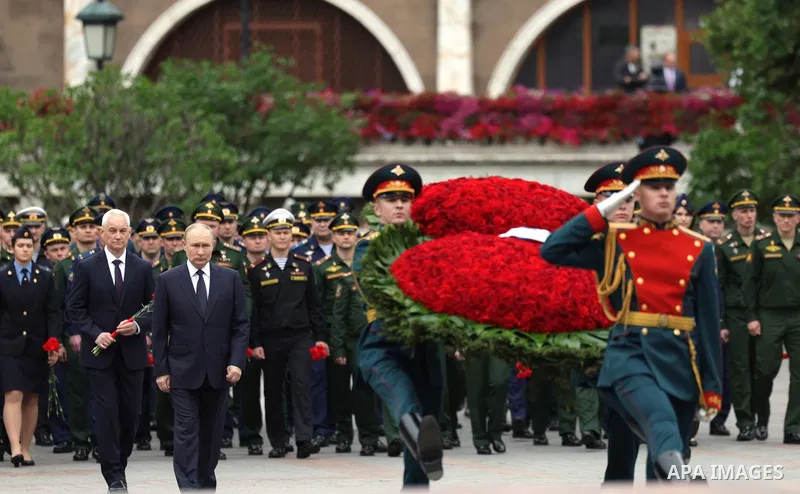 Russia's President Vladimir Putin and Russian Defence Minister Andrei Belousov attend a wreath-laying ceremony at the Tomb of the Unknown Soldier in the Alexandrovsky Garden near the Kremlin wall to commemorate the 84th...