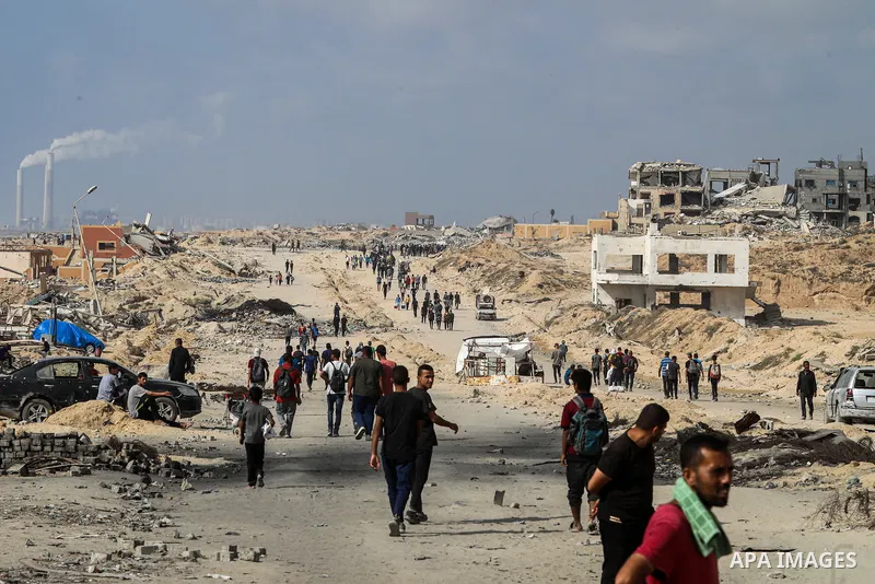 palestinians gather along the Coastal Road in the Al-Sudaniyya area in northern Gaza as they wait to receive humanitarian aid expected to enter through the Zikim crossing, on June 24, 2025 in Gaza. Long queues formed as...