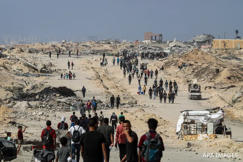 palestinians gather along the Coastal Road in the Al-Sudaniyya area in northern Gaza as they wait to receive humanitarian aid expected to enter through the Zikim crossing, on June 24, 2025 in Gaza. Long queues formed as...