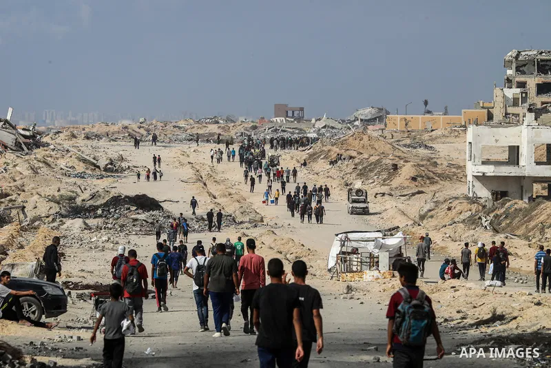 palestinians gather along the Coastal Road in the Al-Sudaniyya area in northern Gaza as they wait to receive humanitarian aid expected to enter through the Zikim crossing, on June 24, 2025 in Gaza. Long queues formed as...
