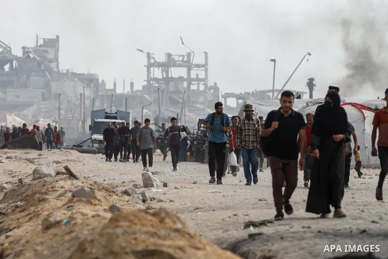 palestinians gather along the Coastal Road in the Al-Sudaniyya area in northern Gaza as they wait to receive humanitarian aid expected to enter through the Zikim crossing, on June 24, 2025 in Gaza. Long queues formed as...