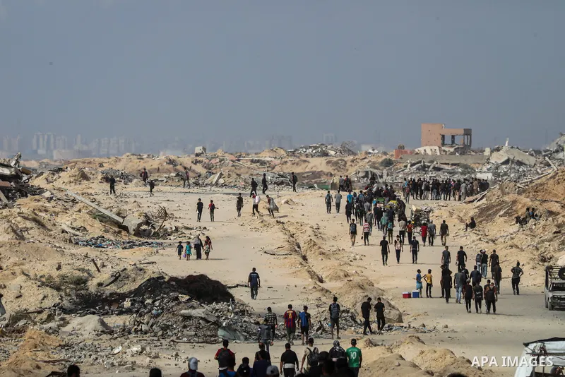 palestinians gather along the Coastal Road in the Al-Sudaniyya area in northern Gaza as they wait to receive humanitarian aid expected to enter through the Zikim crossing, on June 24, 2025 in Gaza. Long queues formed as...
