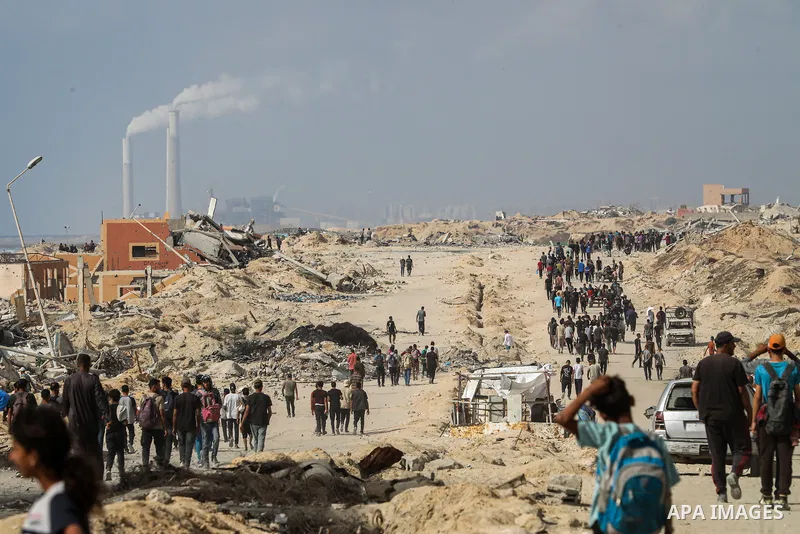 palestinians gather along the Coastal Road in the Al-Sudaniyya area in northern Gaza as they wait to receive humanitarian aid expected to enter through the Zikim crossing, on June 24, 2025 in Gaza. Long queues formed as...