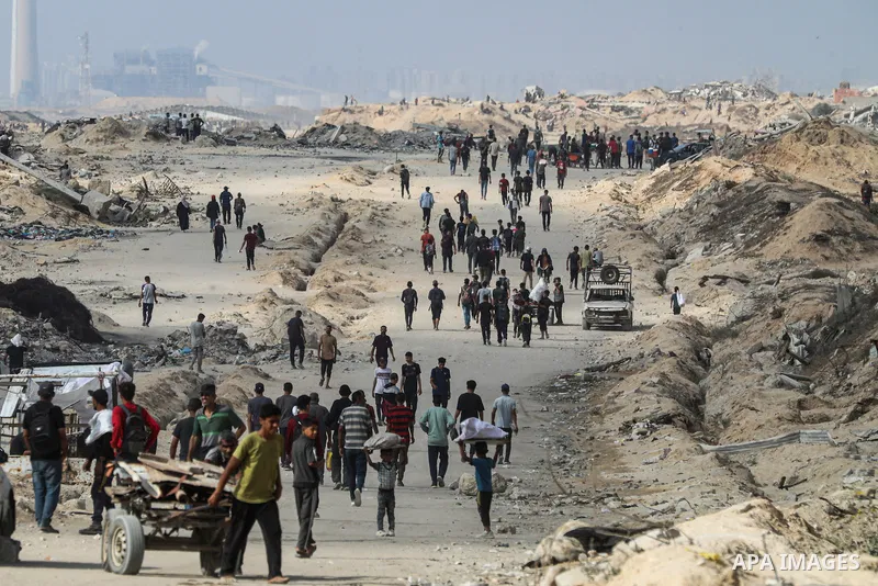 palestinians gather along the Coastal Road in the Al-Sudaniyya area in northern Gaza as they wait to receive humanitarian aid expected to enter through the Zikim crossing, on June 24, 2025 in Gaza. Long queues formed as...