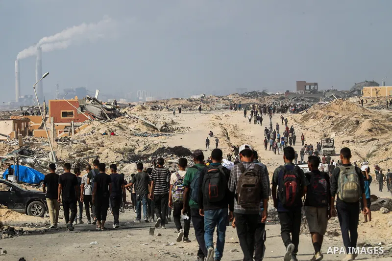 palestinians gather along the Coastal Road in the Al-Sudaniyya area in northern Gaza as they wait to receive humanitarian aid expected to enter through the Zikim crossing, on June 24, 2025 in Gaza. Long queues formed as...