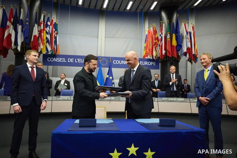 Ukrainian President Volodymyr Zelenskyy, with Council of Europe Secretary General Allen Peers, signs an agreement to establish a special tribunal for the crime of aggression against Ukraine, in The Hague, Netherlands, on...