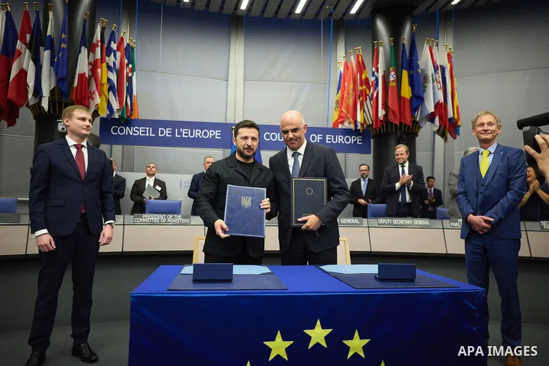 Ukrainian President Volodymyr Zelenskyy, with Council of Europe Secretary General Allen Peers, signs an agreement to establish a special tribunal for the crime of aggression against Ukraine, in The Hague, Netherlands, on...