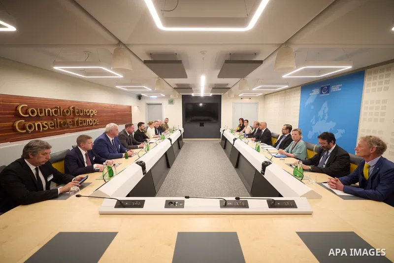 Ukrainian President Volodymyr Zelenskyy, with Council of Europe Secretary General Allen Peers, signs an agreement to establish a special tribunal for the crime of aggression against Ukraine, in The Hague, Netherlands, on...