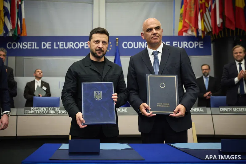 Ukrainian President Volodymyr Zelenskyy, with Council of Europe Secretary General Allen Peers, signs an agreement to establish a special tribunal for the crime of aggression against Ukraine, in The Hague, Netherlands, on...