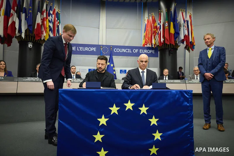 Ukrainian President Volodymyr Zelenskyy, with Council of Europe Secretary General Allen Peers, signs an agreement to establish a special tribunal for the crime of aggression against Ukraine, in The Hague, Netherlands, on...