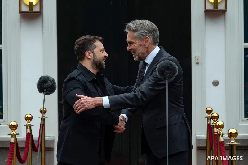 Ukraine's President Volodymyr Zelensky (L) speaks with Netherlands' outgoing Prime Minister Dick Schoof (R) during their bilateral meeting in the gardens of the Catshuis official residence on the sidelines of the two-day...