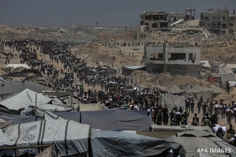Palestinians carry bags of flour that they obtained from aid trucks which entered Gaza through the Zikim crossing point, in Jabalia in the northern Gaza Strip on August 1, 2025. The UN human rights office said on August...
