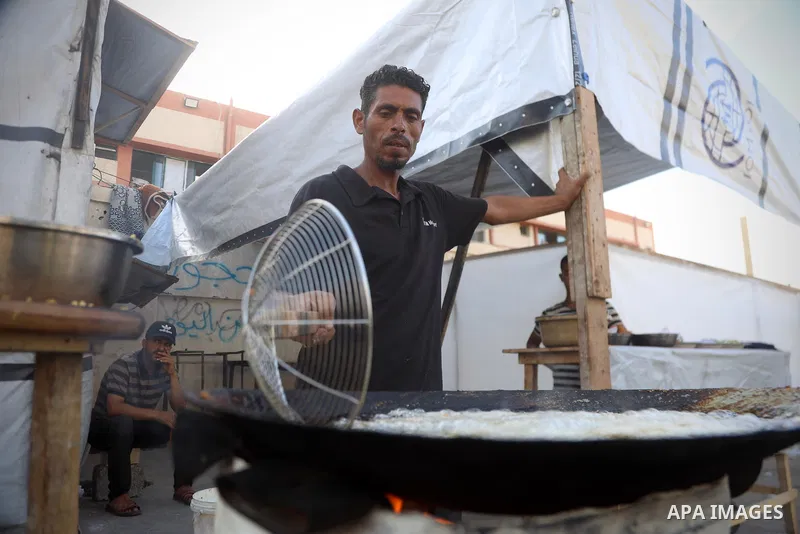 Palestinians, deprived of basic necessities such as shelter, food, and clean water due to ongoing Israeli attacks, buy falafel from street vendors, as it is currently the most affordable and available food option amid se...