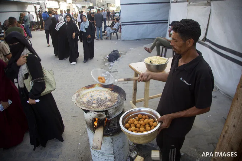 Palestinians, deprived of basic necessities such as shelter, food, and clean water due to ongoing Israeli attacks, buy falafel from street vendors, as it is currently the most affordable and available food option amid se...
