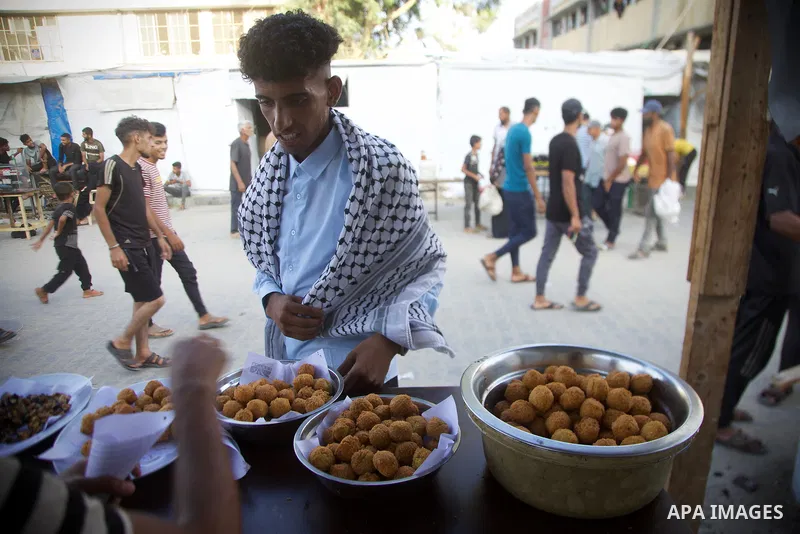 Palestinians, deprived of basic necessities such as shelter, food, and clean water due to ongoing Israeli attacks, buy falafel from street vendors, as it is currently the most affordable and available food option amid se...