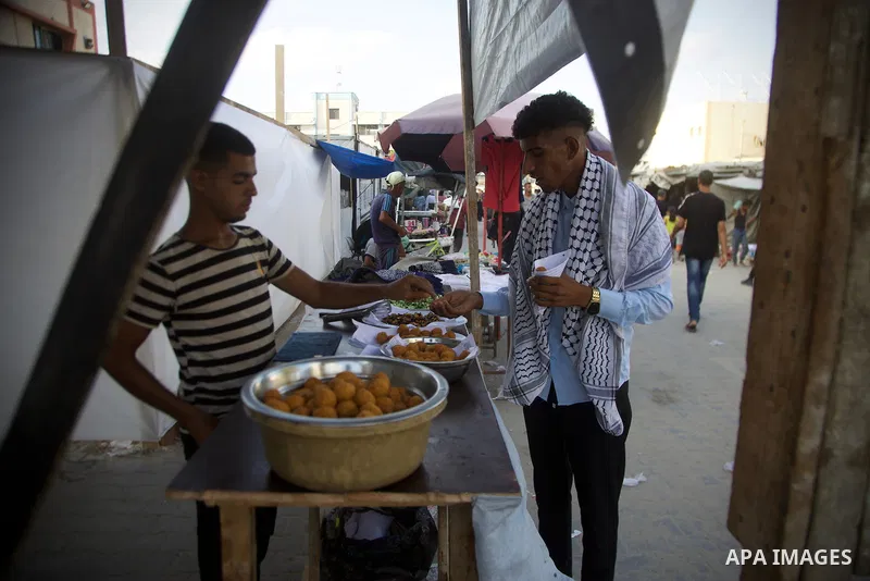 Palestinians, deprived of basic necessities such as shelter, food, and clean water due to ongoing Israeli attacks, buy falafel from street vendors, as it is currently the most affordable and available food option amid se...