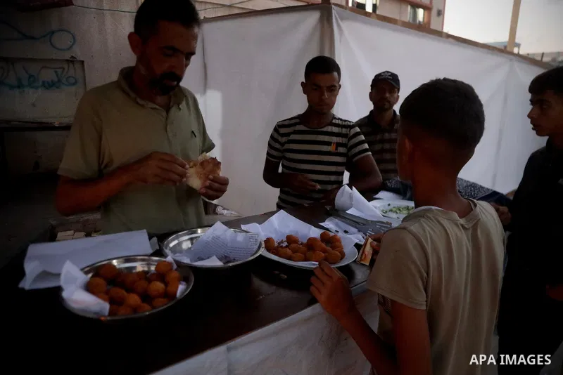 Palestinians, deprived of basic necessities such as shelter, food, and clean water due to ongoing Israeli attacks, buy falafel from street vendors, as it is currently the most affordable and available food option amid se...