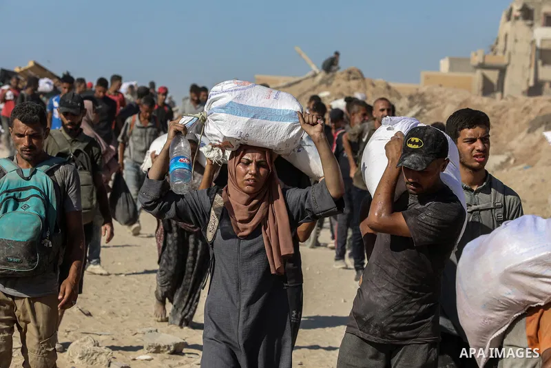 Palestinians suffering from extreme hunger under Israel intense attacks and blockade gather at an aid distribution center near the Zikim border crossing in Gaza to access limited food on August 04, 2025. Crowds tried to...