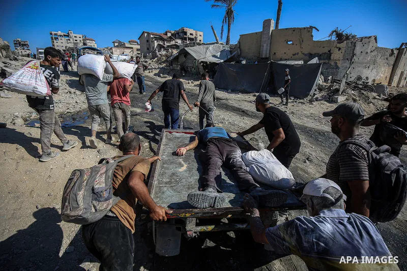 Palestinians carry the bodies of Palestinians killed by Israeli forces as they opened fire on crowd waiting for humanitarian aid in the Zikim area in northern Gaza, on August 04, 2025, reportedly killing and injuring sev...