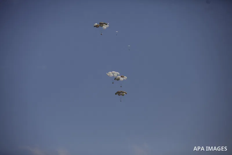 Parachutes drop humanitarian aid over the az-Zawayda area, as residents face starvation due to the blockade imposed by Israel, in Deir al-Balah, Gaza, on August 08, 2025. Photo by Moiz Salhi \ apaimages