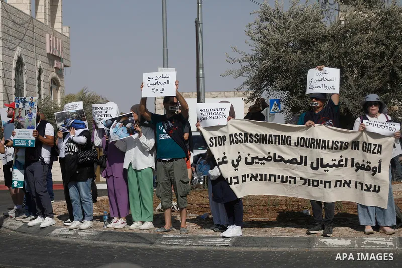 Palestinian and Israeli peace activists protest in the city of Beit Jala near Bethlehem in west bank, on 15 August 2025. against Israel’s killing of journalists in the Gaza Strip, holding banners and signs calling for an...
