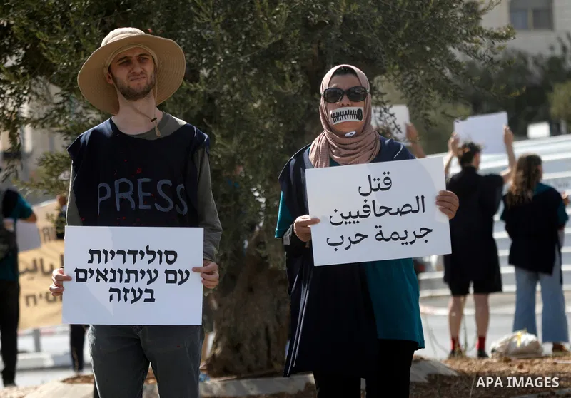 Palestinian and Israeli peace activists protest in the city of Beit Jala near Bethlehem in west bank, on 15 August 2025. against Israel’s killing of journalists in the Gaza Strip, holding banners and signs calling for an...