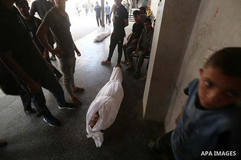 Relatives of the Palestinians, including children, who died as a result of Israeli attacks on different parts of Gaza City, mourn as the dead bodies were taken from the al-Ahly Hospital for burial in Gaza City, Gaza on A...