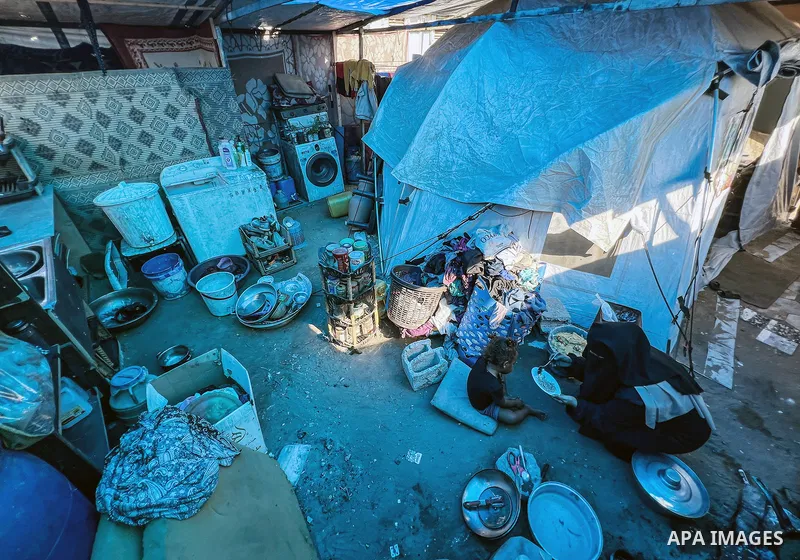Displaced Palestinian families, including orphans, live in a temporary camp within Al-Bureij refugee camp in central Gaza, where worn-out tents have become their only shelter after losing their homes and loved ones durin...