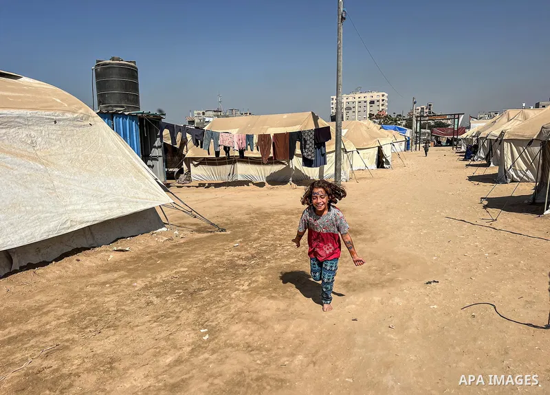 Displaced Palestinian families, including orphans, live in a temporary camp within Al-Bureij refugee camp in central Gaza, where worn-out tents have become their only shelter after losing their homes and loved ones durin...