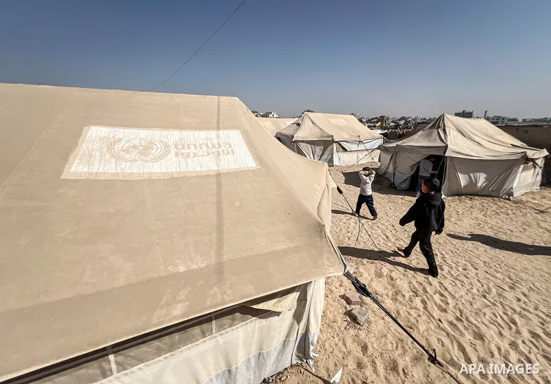 Displaced Palestinian families, including orphans, live in a temporary camp within Al-Bureij refugee camp in central Gaza, where worn-out tents have become their only shelter after losing their homes and loved ones durin...