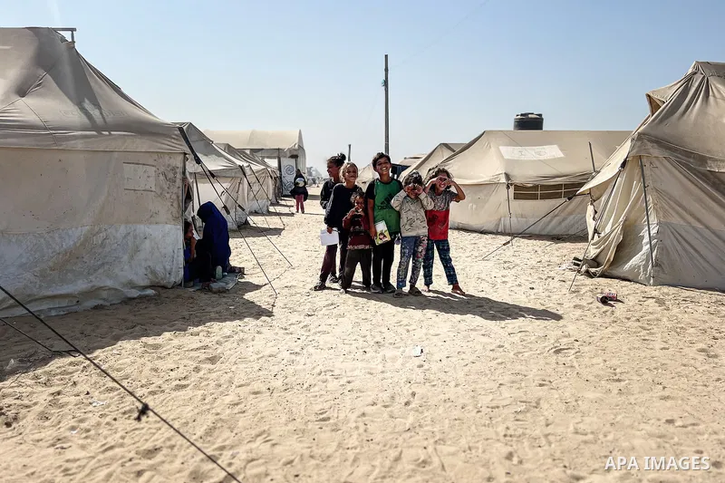 Displaced Palestinian families, including orphans, live in a temporary camp within Al-Bureij refugee camp in central Gaza, where worn-out tents have become their only shelter after losing their homes and loved ones durin...